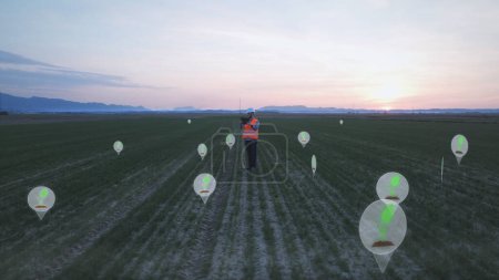 Téléchargez les photos : Man Engineer Collecting Seeds Growing Data on Agricultural Field. Graphiques - en image libre de droit