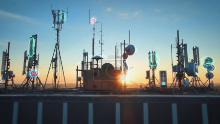 Photo for Rooftop base station at sunset covered with telecom tower antenna with graphics of broadcasting receiver signal quality data coverage - Royalty Free Image