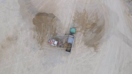 Top Down Aerial View of Loader Loading Crushed Stone Into Truck