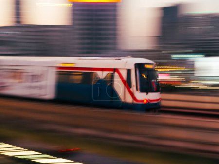 Fast Moving Elevated Train In The City Of Bangkok, Thailand. cityscape of BTS sky train with High speed motion blur effect. Bangkok sky train rush. Electric train, running on the way with business office buildings on the background