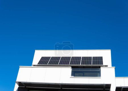 Photo for Modern Architecture and Clean Energy: Solar Panels on White Building. - Royalty Free Image