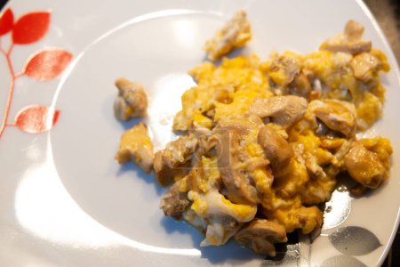 juicy mushroom scrambled eggs on a plate with white decoration