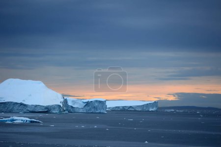 Icebergs under dramatic sky in Disko Bay, Arctic, Greenland, Denmark