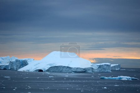 Icebergs under dramatic sky in Disko Bay, Arctic, Greenland, Denmark