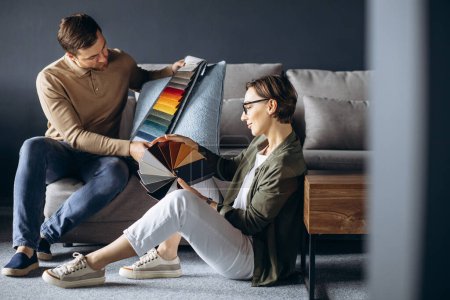 Téléchargez les photos : Designer homme et femme avec écussons textiles et palette de bois au magasin de meubles - en image libre de droit
