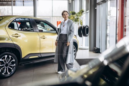 Photo for Business woman choosing a car in a car showroom - Royalty Free Image