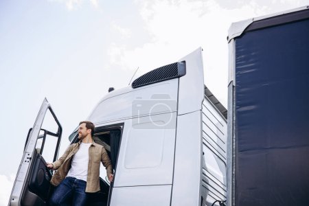 Photo for Truck driver sitting in the cab of his lorry - Royalty Free Image