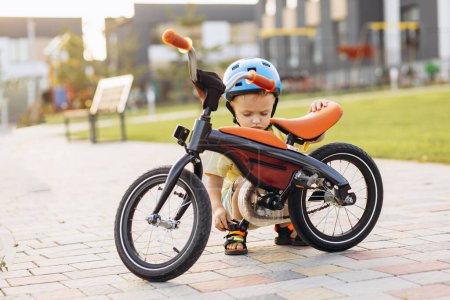 Photo for Cute little boy learning to ride a bicycle - Royalty Free Image