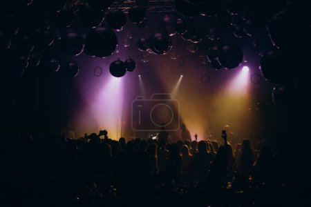 Photo for People clubbing and dancing at the performance - Royalty Free Image