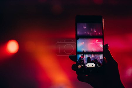 Photo for People clubbing and dancing at the performance and making video on their phones - Royalty Free Image
