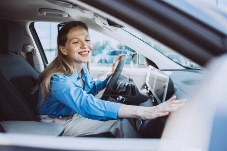 Photo for Woman sitting inside her new electric car - Royalty Free Image