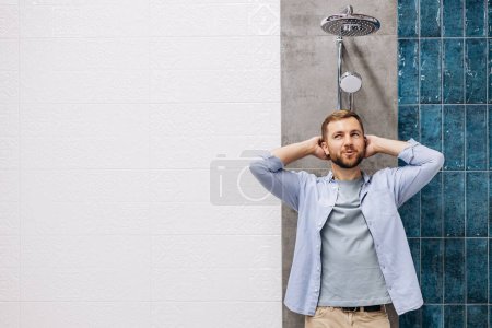 Photo for Man at the building market choosing shower for his bathroom - Royalty Free Image