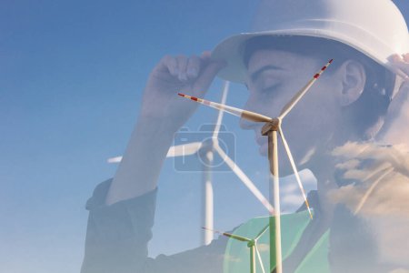 Photo for Portrait of woman engineer standing by the windmill turbines - Royalty Free Image