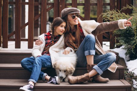Photo for Mother and daughter with dog outside - Royalty Free Image