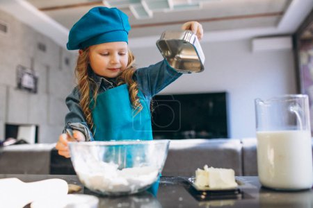 Photo for Little cute girl baking in the kitchen - Royalty Free Image