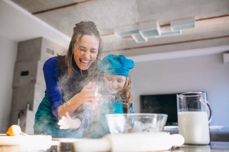 Photo for Mother and daughter baking at home - Royalty Free Image