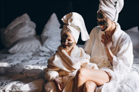 Photo for Mother and daughter doing masks - Royalty Free Image