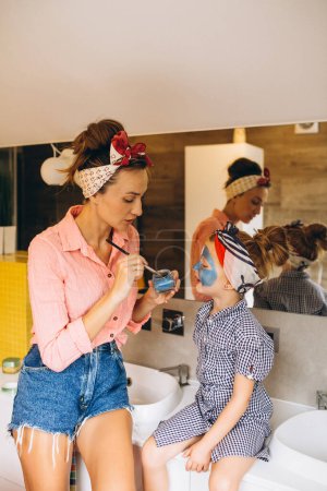 Photo for Mother and daughter making masks home - Royalty Free Image