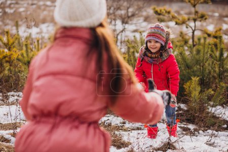 Foto de Mother with little daughter in a winter forest - Imagen libre de derechos