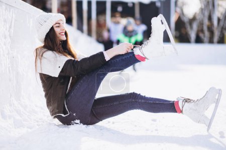 Photo for Young woman ice skating on a rink in a city center - Royalty Free Image