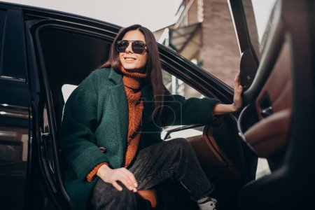 Photo for Young pretty woman sitting in car - Royalty Free Image