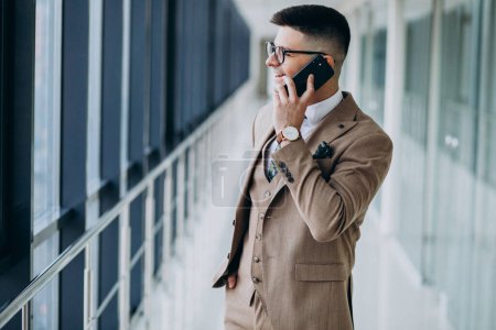 Photo for Young handsome business man standing with phone at the office - Royalty Free Image