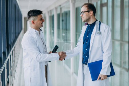 Photo for Two male doctors walking down the corridor - Royalty Free Image