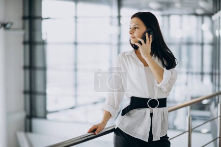 Photo for Young business woman using phone at the office - Royalty Free Image