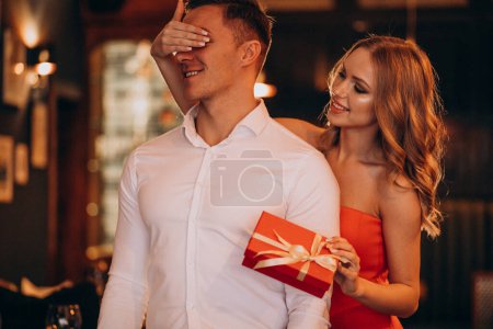 Photo for Woman holding a present for her boyfriend on valentines day - Royalty Free Image
