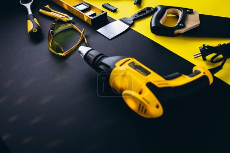 Photo for Set of yellow tools on a black and yellow background - Royalty Free Image