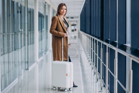 Photo for Business woman with travel bag in airport - Royalty Free Image