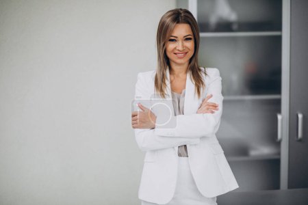 Photo for Young business woman standing in office - Royalty Free Image