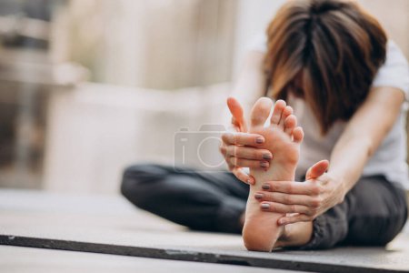 Photo for Young woman practicing yoga at home - Royalty Free Image