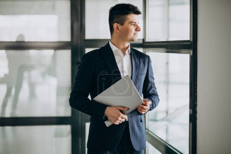 Photo for Young handsome business man with laptop in office - Royalty Free Image