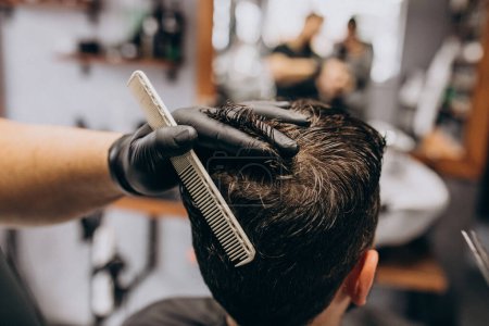 Photo for Client doing hair cut at a barber shop salon - Royalty Free Image