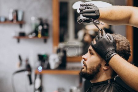 Photo for Client doing hair cut at a barber shop salon - Royalty Free Image