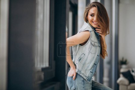 Photo for Young sexy woman st home in denim outfit - Royalty Free Image