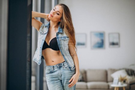 Photo for Young sexy woman st home in denim outfit - Royalty Free Image
