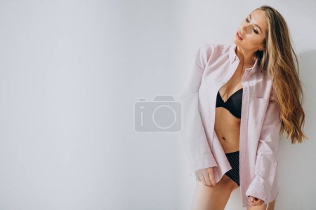 Photo for Young sexy woman at home in pink shirt - Royalty Free Image