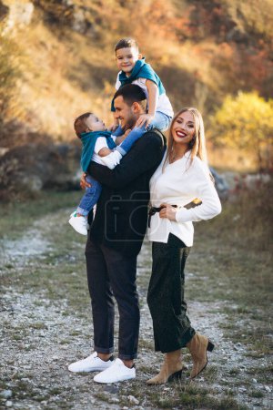 Photo for Young family with two sons together outside the park - Royalty Free Image