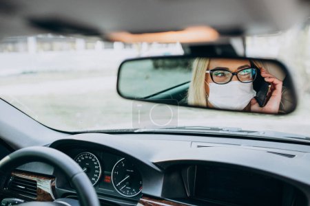Photo for Business woman in protection mask sitting inside a car - Royalty Free Image