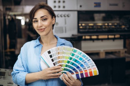 Photo for Woman working in printing house holding swatch palette - Royalty Free Image