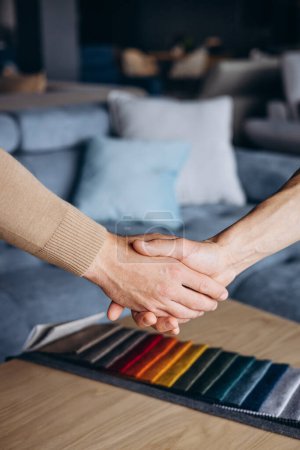 Photo for Textile swatches in furniture store, men shaking hands - Royalty Free Image