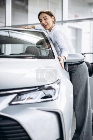 Photo for Beautiful woman hugging a car - Royalty Free Image