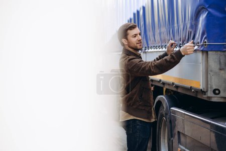 Photo for Truck driver standing by his lorry - Royalty Free Image