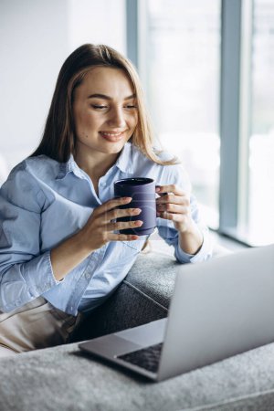 Photo for Business woman working on laptop and drinking coffee - Royalty Free Image