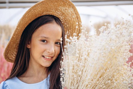 Photo for Cute little girl with decorative dried ears of corn - Royalty Free Image