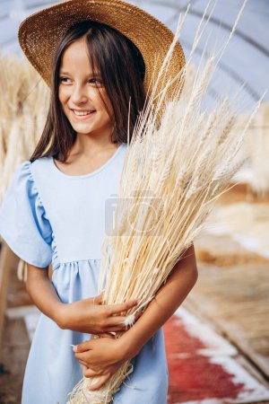 Photo for Cute little girl holding bouquet of straws - Royalty Free Image