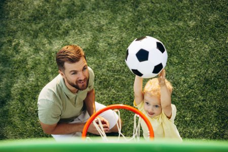 Photo for Father with son throwing ball into the basket - Royalty Free Image