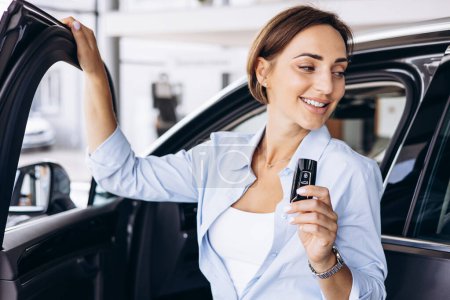 Photo for Woman standing by her new car and holding car keys - Royalty Free Image